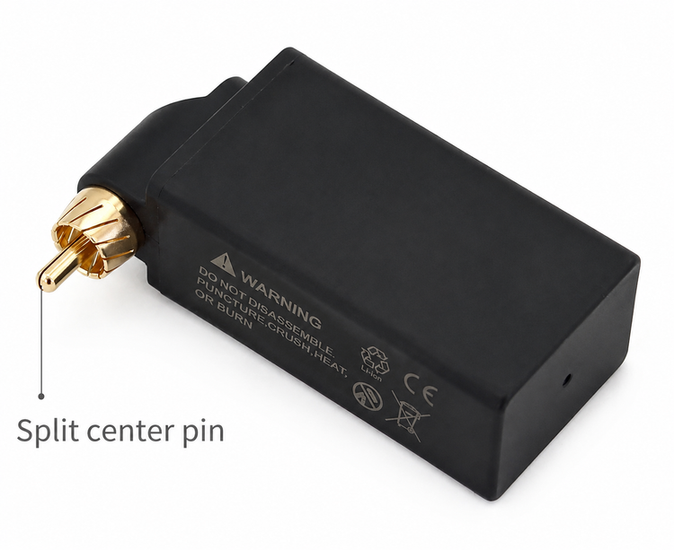 نمای پشت ترانس شارژی تتولند وایرلس با اتصال RCA و پین مرکزی Split Center Pin، بدنه مشکی مات، علائم هشدار و استانداردهای ایمنی روی بدنه، مناسب دستگاههای پن تتو، با پسزمینه سفید